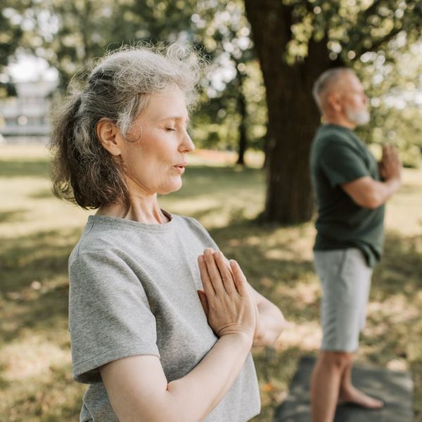 Person meditating peacefully in a bright, serene environment.